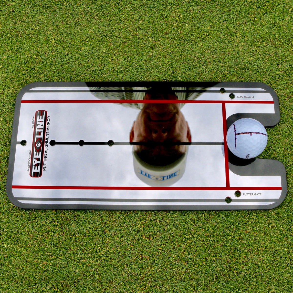 Checking eye position over the ball in the putting mirror
